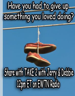 Pair of shoes hanging by their shoelaces from a power line.