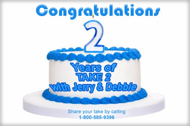 Birthday cake decorated with blue frosting and number two candle