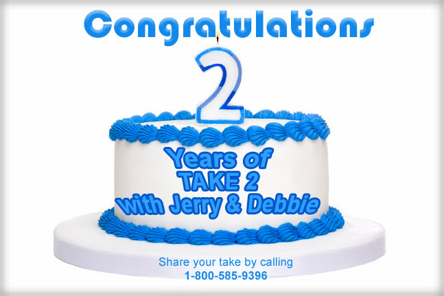 Birthday cake decorated with blue frosting and number two candle